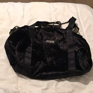 Pink brand black velvet duffel bag.